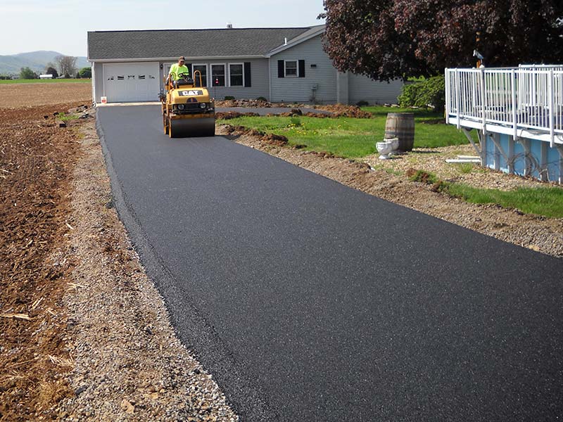 Rolling new asphalt driveway