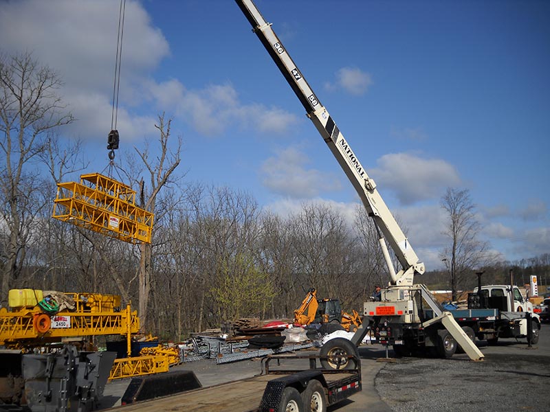 Crane loading scaffolding onto truck