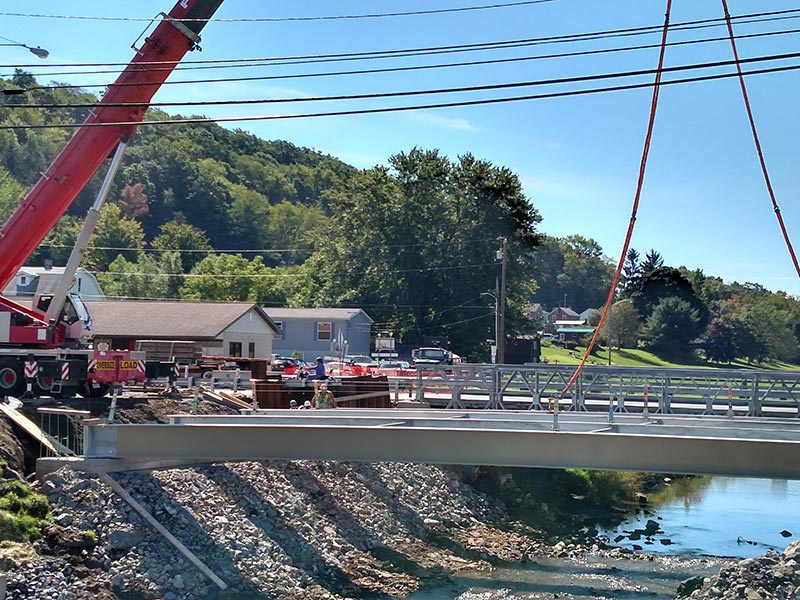 Crane lifting beams into place for bridge construction